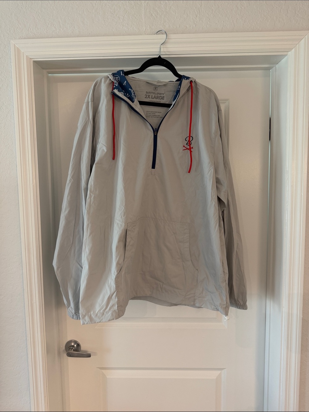 Barstool Light Gray Pullover Windbreaker with Red Drawstrings and logos on hood.
